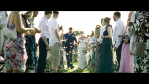 Kerry and Stephen walking down the aisle amidst a shower of petals